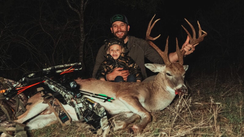 hunter and child with big buck
