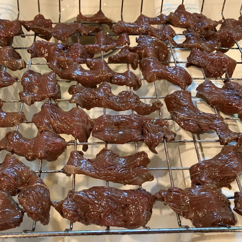 goose meat cut into strips, marinated, and on metal rack to smoke